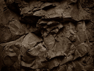 Brown stone background. Mountain close-up. Beautiful rock texture. Detail. Volumetric rocky background for your design. 3D effect.