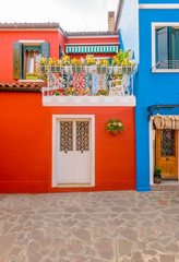 Entrance of a colorful apartment building in Burano, Venice, Italy.