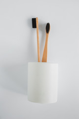 Naklejka premium Natural eco bamboo toothbrush in stand on white background top view