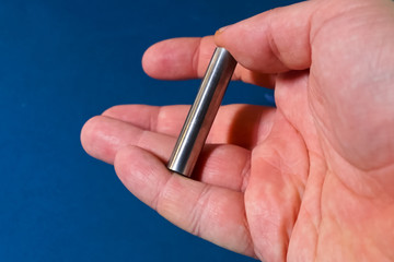 Tungsten rod in the hand. A piece of tungsten for experiments