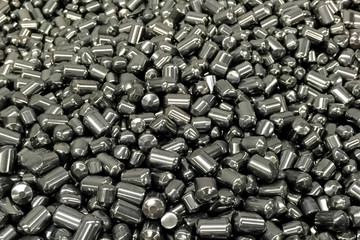 Tungsten cylinders. Ingots of tungsten in a pile.