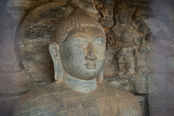 Fototapeta na wymiar Beautiful face of small Buddha statue located inside the artificial cave named the 