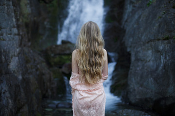 Girl on the background of a waterfall