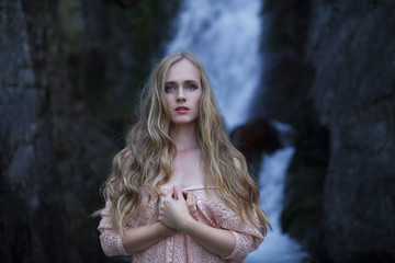 Girl on the background of a waterfall