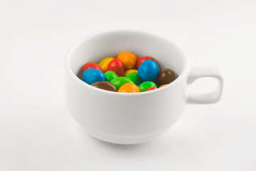 colored candies in a white cup