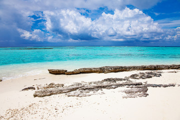 Turquoise blue sea water shore and cloudy sky