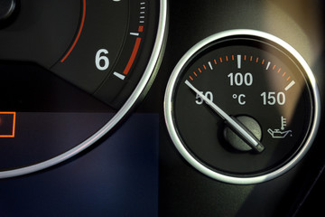 Close up of Oil Temperature Gauges on car dashboard background. 