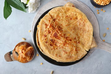 Holi Festival Food - Puran Poli is an Indian sweet flatbread stuffed with mixture of chana dal, jaggery, ghee & cardamom. Usually eaten on Holi or Gudi Padva festival. Recipe ingredients. copy space.