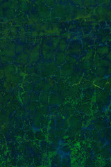 fantastic turquoise painted wall with cracks and peeling paint flakes