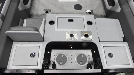 Modern motor boat gray cockpit interior close up, stern transom seats and hatch covers
