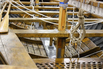 Wooden boat rigging, cockpit view on mast and ropes close-up