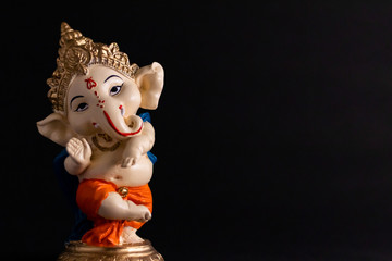 beautiful photography of ganesha statue in front of black background. wisdom concept