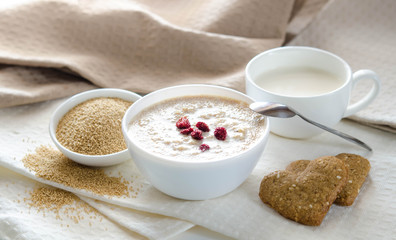 Healthy breakfast. Sesame dry cookies in the form of heart porridge of amaranth with strawberries and yogurt.