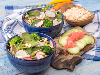 fresh vegetable salad with spinach on the kitchen table. 