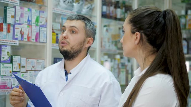 Two young promoters makes a reconciliation of drugs in a pharmacy