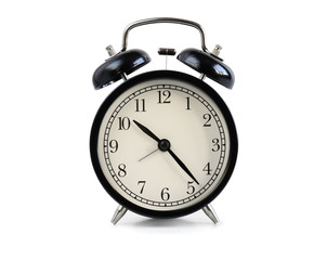 Black old fashioned alarm clock isolated on white background