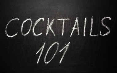 Cocktails 101 written in white chalk on a black chalkboard