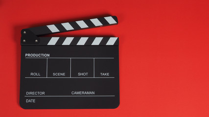 Fototapeta na wymiar clapperboard or clapper board movie slate .It is use in video and cinema industry on red background.