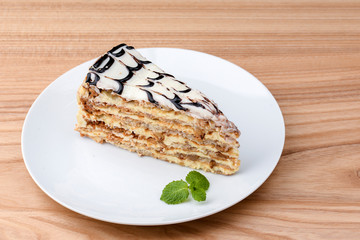 Esterhazy cake sliced on white plate. Sweet dessert with almond meringue dough and buttercream. Austrian cuisine.