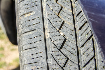 very close up of a wheel tread seen from the front with small stones stuck inside