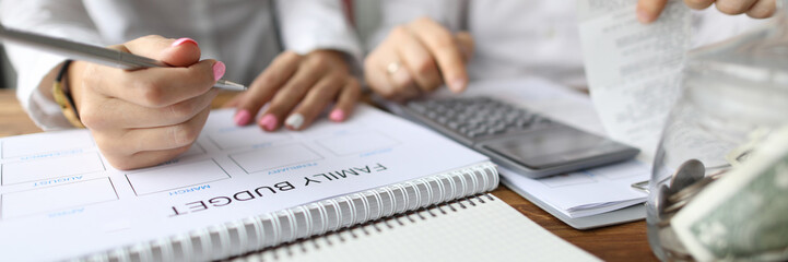 Focus on married couple plan calendar. Husband and wife coping with financial problems. Man with...