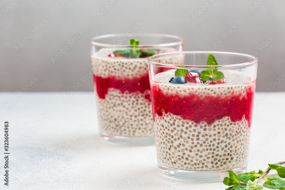 Wall mural Homemade vanilla and raspberry chia pudding made with almond milk.