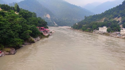 View of the Gangaes with trees, sand and blue sky Shivpuri Rishikesh