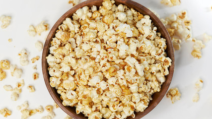 photo sweet popcorn on a white background wooden bowl top view
