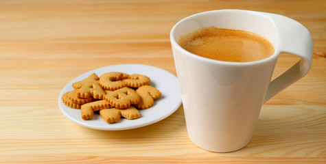 Cup of Hot Coffee with a Plate of Biscuits on Wooden Table	