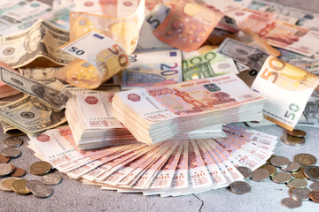 Large stack of banknotes, Russian rubles laying on a grey concrete surface