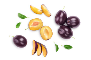 fresh purple plum and half with leaves isolated on white background with clipping path and full depth of field. Top view. Flat lay