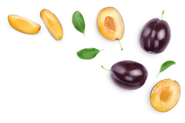 fresh purple plum and half with leaves isolated on white background with clipping path and copy spase for your text. Top view. Flat lay