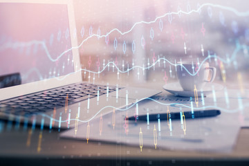 Forex graph hologram on table with computer background. Double exposure. Concept of financial markets.