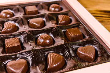 Heap of chocolate candies in a brown box