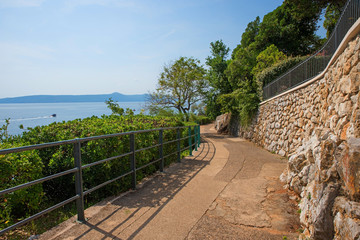 idyllic seaside promenade with fence, along Moscenicka Draga coastlilne, with view to Losinj island, croatia © SusaZoom