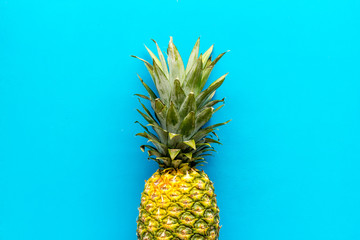 Pineapple - whole fruit - on blue background top-down copy space