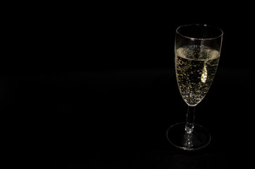Champagne glass on black background