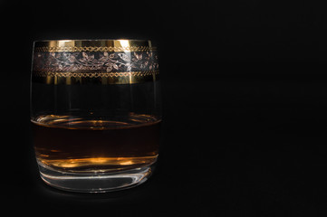 Glass of dark red whiskey, brandy or .bourbon