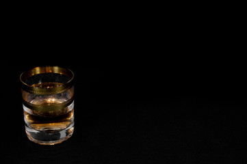 Short Glass of dark red whiskey, brandy or .bourbon