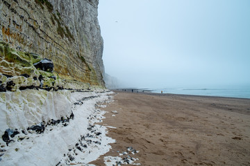 Misty morning landscape of the Natural white chalk cliffs in Etretat, Normandy, France, La Manche or English Channel, on the Coast of the Pays de Caux area. 