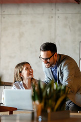 Business people having fun and chatting at workplace office