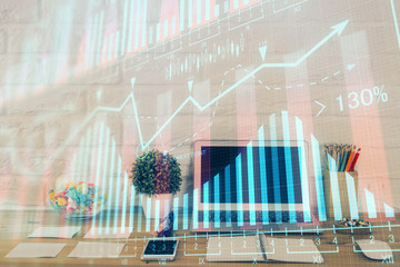 Double exposure of graph and financial info and work space with computer background. Concept of...