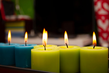 blue and green candles burning in the dark