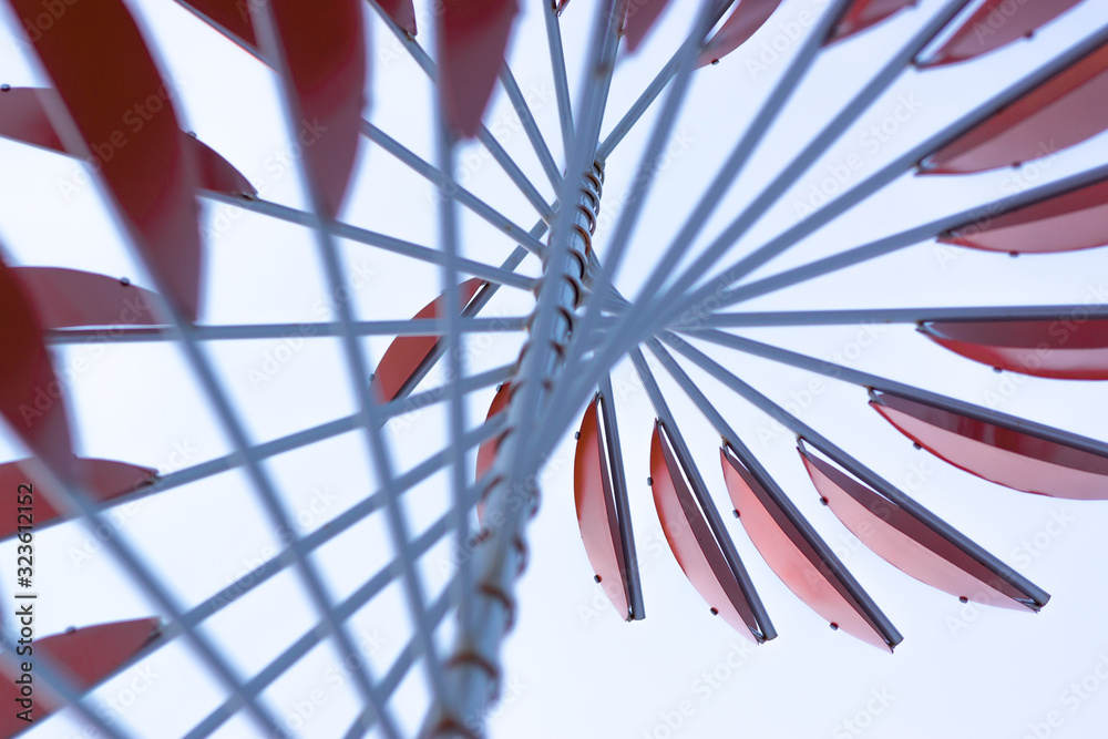 Wall mural abstract red windmill on a blue sky background 3