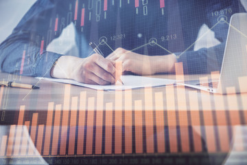 Double exposure hands with stock market chart.