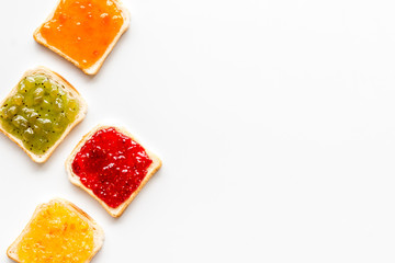 Fototapeta na wymiar Toast with jam. Colorful set on white background top-down frame copy space