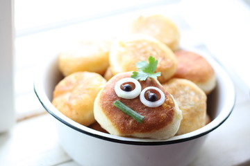 Funny face on a fried meat patty