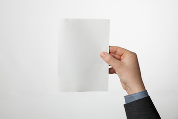 A5 white paper brochure, flyer mockup. Blank of presentation template in hand.