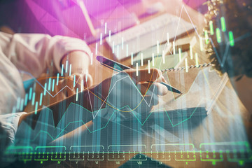 Financial forex charts displayed on woman's hand taking notes background. Concept of research. Double exposure