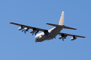 Fototapeta na wymiar Back view of mid flight military transport aircraft; Mountain View, California